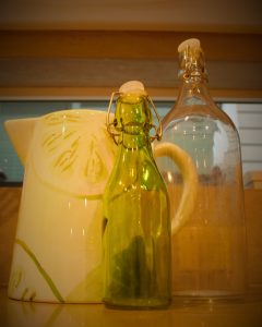 Lime print pitcher and 2 glass water bottles